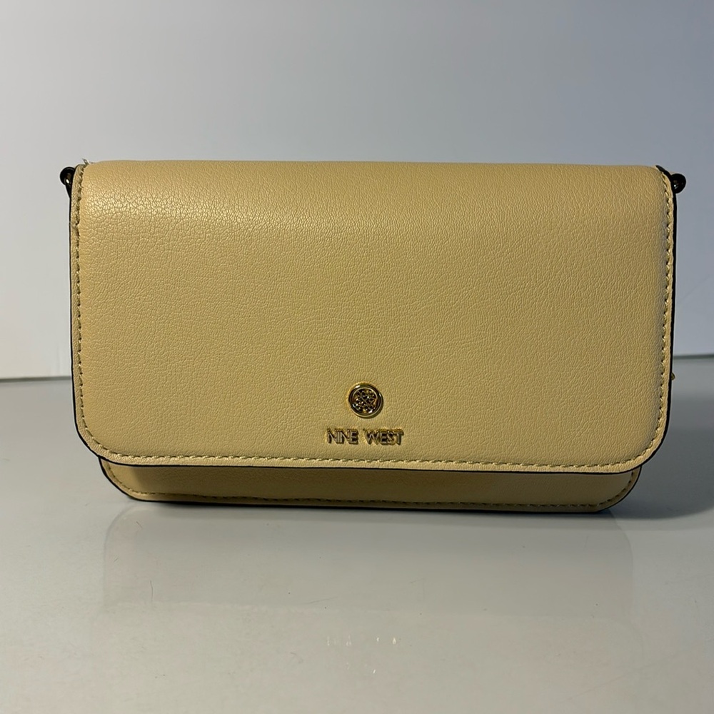Nine West cross body or clutch purse in a beige color with gold hardware